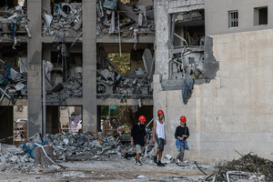 People inspect a residential building in Be’er Sheva destroyed by an Iranian ballistic missile, in which four Israelis were killed.