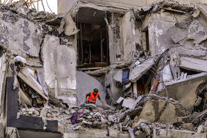 A man inspects a residential building in Be’er Sheva destroyed by an Iranian ballistic missile, in which four Israelis were killed.