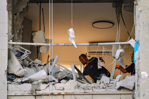 An Israeli inspects a residential building in Be’er Sheva destroyed by an Iranian ballistic missile, in which four Israelis were killed.