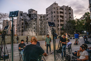 Foreign and Israeli press broadcasters seen near a residential building in Beíer Sheva destroyed by an Iranian ballistic missile, in which four Israelis were killed.