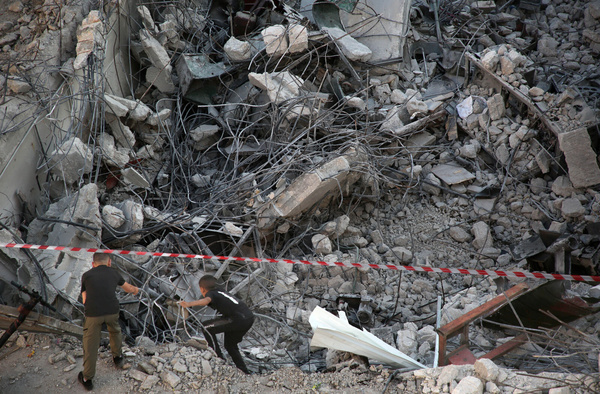 Palestinians inspect a blacksmith workshop after it was demolished by Israeli military bulldozers in the eastern West Bank. The Israeli occupational forces destroyed a blacksmith workshop claiming that it was used to manufacture combat equipment.