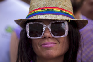 A woman looks on during the High Heel Race on Pelayo Street. The 26th edition of the High Heel Race was held in the LGBTQ+ neighborhood of Chueca, a sporting and festive event that involves running in heels.
