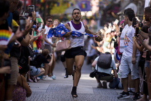 A competitor in heels seen in action, during the High Heel Race on Pelayo Street. The 26th edition of the High Heel Race was held in the LGBTQ+ neighborhood of Chueca, a sporting and festive event that involves running in heels.