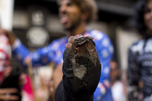 One of the winners shows the public how his foot looked in the shoe after winning the High Heel Race on Pelayo Street. The 26th edition of the High Heel Race was held in the LGBTQ+ neighborhood of Chueca, a sporting and festive event that involves running in heels.