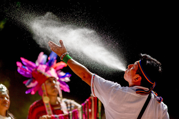 A participant from a Peruvian folklore group blows burning water into the air to purify the ceremony, during the celebration of Inti Raymi, the "Andean Sun Festival," at Retiro Park which was organized by the Embassies of Ecuador, Bolivia, and Peru in Spain. Inti Raymi, the ancient celebration of the Andean peoples of South America, marks the beginning of the winter solstice in the southern hemisphere and a new agricultural cycle.