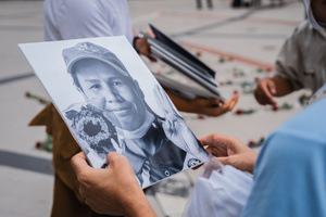 A participant holds a portrait of a detained activist during a “People’s Amnesty” vigil. People gathered outside Bangkok Art and Culture Centre for a candlelight vigil titled “Light Up Hope for the People’s Amnesty.” Organized ahead of a parliamentary debate on the 16 July 2025, the event featured personal testimonies, portraits of 50 political detainees, and a red rose display reading “Amnesty 112.” Participants called for the passage of a comprehensive amnesty bill covering cases under Section 112 of the Thai Criminal Code.