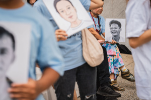 Participants hold portraits of a detained activist during a “People’s Amnesty” vigil. People gathered outside Bangkok Art and Culture Centre for a candlelight vigil titled “Light Up Hope for the People’s Amnesty.” Organized ahead of a parliamentary debate on the 16 July 2025, the event featured personal testimonies, portraits of 50 political detainees, and a red rose display reading “Amnesty 112.” Participants called for the passage of a comprehensive amnesty bill covering cases under Section 112 of the Thai Criminal Code.