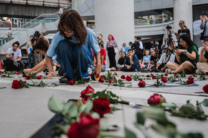 Participants arrange red roses on the ground during the “People’s Amnesty” vigil. People gathered outside Bangkok Art and Culture Centre for a candlelight vigil titled “Light Up Hope for the People’s Amnesty.” Organized ahead of a parliamentary debate on the 16 July 2025, the event featured personal testimonies, portraits of 50 political detainees, and a red rose display reading “Amnesty 112.” Participants called for the passage of a comprehensive amnesty bill covering cases under Section 112 of the Thai Criminal Code.