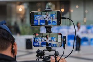A speaker is livestreamed via mobile phones during the “People’s Amnesty” vigil. People gathered outside Bangkok Art and Culture Centre for a candlelight vigil titled “Light Up Hope for the People’s Amnesty.” Organized ahead of a parliamentary debate on the 16 July 2025, the event featured personal testimonies, portraits of 50 political detainees, and a red rose display reading “Amnesty 112.” Participants called for the passage of a comprehensive amnesty bill covering cases under Section 112 of the Thai Criminal Code.