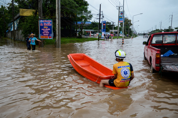 A young rescue worker stands by with a boat, ready to assist residents needing to navigate or evacuate the flooded neighborhood. Heavy rain from Severe Tropical Storm Wipha caused widespread and severe flooding across northern Thailand in late July 2025, with the event being described as the worst in decades for some provinces. In areas like Mae Sot, Tak Province, the continuous rain caused local streams to overflow and submerge roads. The situation became much more serious when the Moei River (also known as the Thaungyin River), which forms the border between Thailand and Myanmar, rose to dangerous levels. This led to major flooding in communities on both sides: Mae Sot, Thailand, and the neighboring town of Myawaddy, Myanmar. Although the Thai government had issued mobile phone alerts, the speed of the rising water caught many residents off guard, and authorities continue to warn of more rain in Tak and other affected provinces.