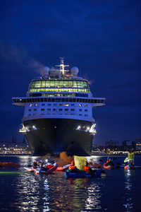 Extinction Rebellion climate activists in kayaks at pre-dawn attempt to block the path of Luxury Ocean liner the "Celebrity Eclipse" from docking at the Passages Terminal. A little before sunrise, climate activists from Extinction Rebellion, Netherlands attempted to block the path of Luxury Ocean liner the ‘Celebrity Eclipse’ from docking at the Passages Terminal in Amsterdam. The ‘Celebrity Eclipse’ is operated by Celebrity Cruises, a subsidiary of Royal Caribbean Group. The activist numbered 30 in all, with the majority in 2-person kayaks. ‘Cruise ships are floating environmental disasters. They should not be allowed in Dutch waters. We demand strict and binding national and international environmental standards and regulations, as well as strict enforcement and sanctions policy.