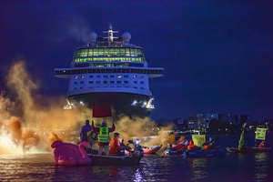 Extinction Rebellion climate activists in kayaks at pre-dawn attempt to block the path of Luxury Ocean liner the "Celebrity Eclipse" from docking at the Passages Terminal. A little before sunrise, climate activists from Extinction Rebellion, Netherlands attempted to block the path of Luxury Ocean liner the ‘Celebrity Eclipse’ from docking at the Passages Terminal in Amsterdam. The ‘Celebrity Eclipse’ is operated by Celebrity Cruises, a subsidiary of Royal Caribbean Group. The activists numbered 30 in all, with the majority in 2-person kayaks stating that "Cruise ships are floating environmental disasters. They should not be allowed in Dutch waters. We demand strict and binding national and international environmental standards and regulations, as well as strict enforcement and sanctions policy."