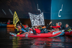 Extinction Rebellion activists seated in kayaks hold large banners, expressing their opinion during an attempt to block the path of Luxury Ocean liner the "Celebrity Eclipse" from docking at the Passages Terminal. A little before sunrise, climate activists from Extinction Rebellion, Netherlands attempted to block the path of Luxury Ocean liner the ‘Celebrity Eclipse’ from docking at the Passages Terminal in Amsterdam. The ‘Celebrity Eclipse’ is operated by Celebrity Cruises, a subsidiary of Royal Caribbean Group. The activist numbered 30 in all, with the majority in 2-person kayaks. ‘Cruise ships are floating environmental disasters. They should not be allowed in Dutch waters. We demand strict and binding national and international environmental standards and regulations, as well as strict enforcement and sanctions policy.