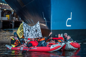 Extinction Rebellion activists seated in kayaks hold large banners, expressing their opinion during an attempt to block the path of Luxury Ocean liner the "Celebrity Eclipse" from docking at the Passages Terminal. A little before sunrise, climate activists from Extinction Rebellion, Netherlands attempted to block the path of Luxury Ocean liner the ‘Celebrity Eclipse’ from docking at the Passages Terminal in Amsterdam. The ‘Celebrity Eclipse’ is operated by Celebrity Cruises, a subsidiary of Royal Caribbean Group. The activists numbered 30 in all, with the majority in 2-person kayaks stating that "Cruise ships are floating environmental disasters. They should not be allowed in Dutch waters. We demand strict and binding national and international environmental standards and regulations, as well as strict enforcement and sanctions policy."