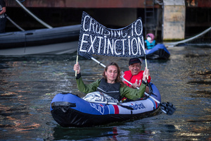 Extinction Rebellion activists seated in kayaks hold large banners, expressing their opinion during an attempt to block the path of Luxury Ocean liner the "Celebrity Eclipse" from docking at the Passages Terminal. A little before sunrise, climate activists from Extinction Rebellion, Netherlands attempted to block the path of Luxury Ocean liner the ‘Celebrity Eclipse’ from docking at the Passages Terminal in Amsterdam. The ‘Celebrity Eclipse’ is operated by Celebrity Cruises, a subsidiary of Royal Caribbean Group. The activists numbered 30 in all, with the majority in 2-person kayaks stating that "Cruise ships are floating environmental disasters. They should not be allowed in Dutch waters. We demand strict and binding national and international environmental standards and regulations, as well as strict enforcement and sanctions policy."