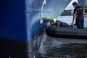 Terminal workers remove profanity from the side of the "Celebrity Eclipse" during an attempt to block the path of Luxury liner from docking at the Passages Terminal. A little before sunrise, climate activists from Extinction Rebellion, Netherlands attempted to block the path of Luxury Ocean liner the ‘Celebrity Eclipse’ from docking at the Passages Terminal in Amsterdam. The ‘Celebrity Eclipse’ is operated by Celebrity Cruises, a subsidiary of Royal Caribbean Group. The activists numbered 30 in all, with the majority in 2-person kayaks stating that "Cruise ships are floating environmental disasters. They should not be allowed in Dutch waters. We demand strict and binding national and international environmental standards and regulations, as well as strict enforcement and sanctions policy."