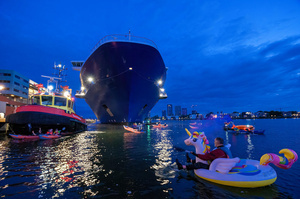 Extinction Rebellion climate activists in kayaks at pre-dawn attempt to block the path of Luxury Ocean liner the "Celebrity Eclipse" from docking at the Passages Terminal. A little before sunrise, climate activists from Extinction Rebellion, Netherlands attempted to block the path of Luxury Ocean liner the ‘Celebrity Eclipse’ from docking at the Passages Terminal in Amsterdam. The ‘Celebrity Eclipse’ is operated by Celebrity Cruises, a subsidiary of Royal Caribbean Group. The activists numbered 30 in all, with the majority in 2-person kayaks stating that "Cruise ships are floating environmental disasters. They should not be allowed in Dutch waters. We demand strict and binding national and international environmental standards and regulations, as well as strict enforcement and sanctions policy."