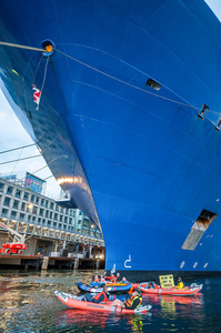 Extinction Rebellion climate activists in kayaks, attempt to block the path of Luxury Ocean liner the "Celebrity Eclipse" from docking at the Passages Terminal. A little before sunrise, climate activists from Extinction Rebellion, Netherlands attempted to block the path of Luxury Ocean liner the ‘Celebrity Eclipse’ from docking at the Passages Terminal in Amsterdam. The ‘Celebrity Eclipse’ is operated by Celebrity Cruises, a subsidiary of Royal Caribbean Group. The activists numbered 30 in all, with the majority in 2-person kayaks stating that "Cruise ships are floating environmental disasters. They should not be allowed in Dutch waters. We demand strict and binding national and international environmental standards and regulations, as well as strict enforcement and sanctions policy."