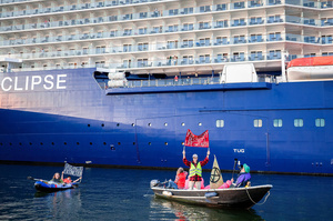 Extinction Rebellion activists seated in kayaks hold large banners, express their opinion during an attempt to block the path of Luxury Ocean liner the "Celebrity Eclipse" from docking at the Passages Terminal. A little before sunrise, climate activists from Extinction Rebellion, Netherlands attempted to block the path of Luxury Ocean liner the ‘Celebrity Eclipse’ from docking at the Passages Terminal in Amsterdam. The ‘Celebrity Eclipse’ is operated by Celebrity Cruises, a subsidiary of Royal Caribbean Group. The activists numbered 30 in all, with the majority in 2-person kayaks stating that "Cruise ships are floating environmental disasters. They should not be allowed in Dutch waters. We demand strict and binding national and international environmental standards and regulations, as well as strict enforcement and sanctions policy."