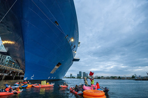 Extinction Rebellion climate activists in kayaks, attempt to block the path of Luxury Ocean liner the "Celebrity Eclipse" from docking at the Passages Terminal. A little before sunrise, climate activists from Extinction Rebellion, Netherlands attempted to block the path of Luxury Ocean liner the ‘Celebrity Eclipse’ from docking at the Passages Terminal in Amsterdam. The ‘Celebrity Eclipse’ is operated by Celebrity Cruises, a subsidiary of Royal Caribbean Group. The activists numbered 30 in all, with the majority in 2-person kayaks stating that "Cruise ships are floating environmental disasters. They should not be allowed in Dutch waters. We demand strict and binding national and international environmental standards and regulations, as well as strict enforcement and sanctions policy."