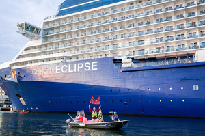 Extinction Rebellion activists seated in kayaks hold large banners, express their opinion during an attempt to block the path of Luxury Ocean liner the "Celebrity Eclipse" from docking at the Passages Terminal. A little before sunrise, climate activists from Extinction Rebellion, Netherlands attempted to block the path of Luxury Ocean liner the ‘Celebrity Eclipse’ from docking at the Passages Terminal in Amsterdam. The ‘Celebrity Eclipse’ is operated by Celebrity Cruises, a subsidiary of Royal Caribbean Group. The activists numbered 30 in all, with the majority in 2-person kayaks stating that "Cruise ships are floating environmental disasters. They should not be allowed in Dutch waters. We demand strict and binding national and international environmental standards and regulations, as well as strict enforcement and sanctions policy."