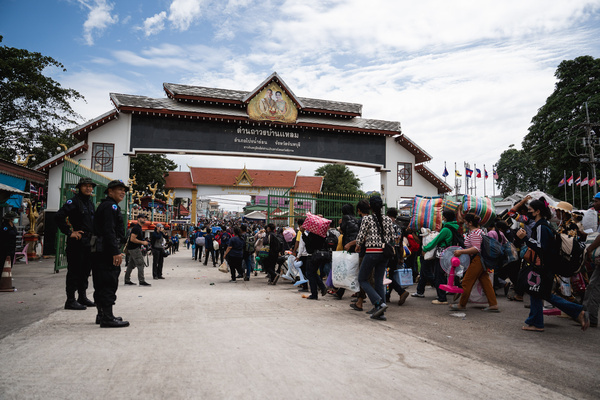 Cambodians hurry through Ban Laem checkpoint. Thousands of Cambodians returned home through Ban Laem checkpoint over the weekend as tensions escalated along the Thai-Cambodian border. The movement occurred with officials ensuring safe passage.