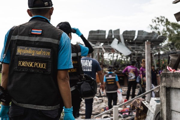 Forensic officers enter the scene of a deadly explosion during the aftermath.
after the accident. A powerful explosion tore through a house in Ban Pho, where fireworks were reportedly being assembled. The blast killed at least nine people, all believed to be women, and injured two others. Nearby homes were also damaged in the incident.