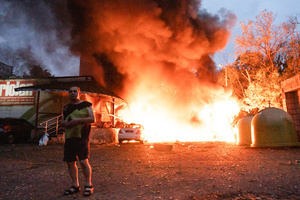 A resident walks past a fire following the Russian missile attack. On July 31, 2025, a massive Russian missile and drone attack on Kyiv left at least 16 people dead, including two children, and caused widespread destruction. Ukrainian forces intercepted most of the 309 drones and eight cruise missiles, but some struck residential areas, collapsing a section of a nine-story building. Over 100 buildings were damaged across 27 locations, including schools, hospitals, and homes.