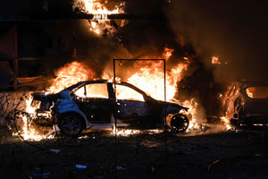 View of burning cars following the Russian missile attack. On July 31, 2025, a massive Russian missile and drone attack on Kyiv left at least 16 people dead, including two children, and caused widespread destruction. Ukrainian forces intercepted most of the 309 drones and eight cruise missiles, but some struck residential areas, collapsing a section of a nine-story building. Over 100 buildings were damaged across 27 locations, including schools, hospitals, and homes.