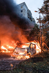 View of a burning car following the Russian missile attack. On July 31, 2025, a massive Russian missile and drone attack on Kyiv left at least 16 people dead, including two children, and caused widespread destruction. Ukrainian forces intercepted most of the 309 drones and eight cruise missiles, but some struck residential areas, collapsing a section of a nine-story building. Over 100 buildings were damaged across 27 locations, including schools, hospitals, and homes.