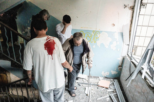 Young men assisting elderly residents in evacuating from the residential building following the Russian missile attack. On July 31, 2025, a massive Russian missile and drone attack on Kyiv left at least 16 people dead, including two children, and caused widespread destruction. Ukrainian forces intercepted most of the 309 drones and eight cruise missiles, but some struck residential areas, collapsing a section of a nine-story building. Over 100 buildings were damaged across 27 locations, including schools, hospitals, and homes.