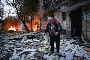 An elderly resident is leaving his damaged home following the Russian missile attack. On July 31, 2025, a massive Russian missile and drone attack on Kyiv left at least 16 people dead, including two children, and caused widespread destruction. Ukrainian forces intercepted most of the 309 drones and eight cruise missiles, but some struck residential areas, collapsing a section of a nine-story building. Over 100 buildings were damaged across 27 locations, including schools, hospitals, and homes.