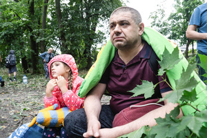 Father and daughter sit near their damaged home following the Russian missile attack. On July 31, 2025, a massive Russian missile and drone attack on Kyiv left at least 16 people dead, including two children, and caused widespread destruction. Ukrainian forces intercepted most of the 309 drones and eight cruise missiles, but some struck residential areas, collapsing a section of a nine-story building. Over 100 buildings were damaged across 27 locations, including schools, hospitals, and homes.