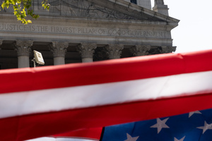 The American flag seen in front of the New York District Court. Demonstrators of the group "Extinction Rebellion" protest outside of the Immigration Court at 26 Federal Plaza against ICE detainments and inhumane holding conditions.