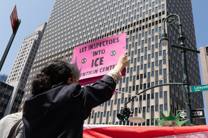 A woman holds a sign that reads "Let Inspectors Into ICE Detention Centers". Demonstrators of the group "Extinction Rebellion" protest outside of the Immigration Court at 26 Federal Plaza against ICE detainments and inhumane holding conditions.