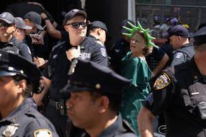 A woman dressed as the Statue of Liberty seen arrested by NYPD. Demonstrators of the group "Extinction Rebellion" protest outside of the Immigration Court at 26 Federal Plaza against ICE detainments and inhumane holding conditions.