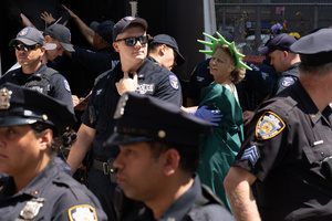 A woman dressed as the Statue of Liberty seen arrested by NYPD. Demonstrators of the group "Extinction Rebellion" protest outside of the Immigration Court at 26 Federal Plaza against ICE detainments and inhumane holding conditions.