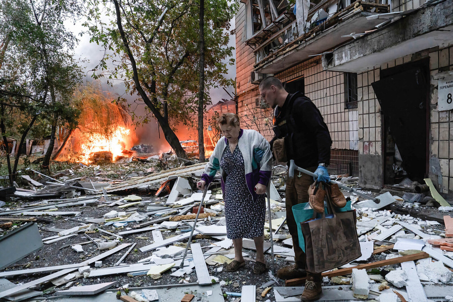 A man assists an elderly resident in evacuating from her damaged home following the Russian missile attack. On July 31, 2025, a massive Russian missile and drone attack on Kyiv left at least 16 people dead, including two children, and caused widespread destruction. Ukrainian forces intercepted most of the 309 drones and eight cruise missiles, but some struck residential areas, collapsing a section of a nine-story building. Over 100 buildings were damaged across 27 locations, including schools, hospitals, and homes.