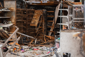 Burnt shelves and debris inside a 7-Eleven at a PTT station in Kantharalak, weeks after a Cambodian border clash rocket strike. Three weeks after the Cambodian border clash, Kantharalak still bears the scars, including the July 24 rocket strike on a PTT station that killed eight civilians and injured several others. The station remains closed, leaving more than 50 employees in limbo as compensation issues remain unresolved.