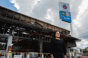 Kamonrat Phonsettalert, owner of the PTT station in Kantharalak, stands in front of the destroyed 7-Eleven weeks after a rocket strike during the Thai-Cambodian border clash killed seven and injured one. Three weeks after the Cambodian border clash, Kantharalak still bears the scars, including the July 24 rocket strike on a PTT station that killed eight civilians and injured several others. The station remains closed, leaving more than 50 employees in limbo as compensation issues remain unresolved.