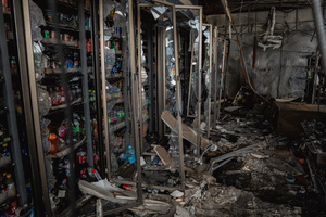 Shattered refrigerators and burnt debris inside the destroyed 7-Eleven at a PTT station in Kantharalak, weeks after a rocket strike during the Thai-Cambodian border clash. Three weeks after the Cambodian border clash, Kantharalak still bears the scars, including the July 24 rocket strike on a PTT station that killed eight civilians and injured several others. The station remains closed, leaving more than 50 employees in limbo as compensation issues remain unresolved.