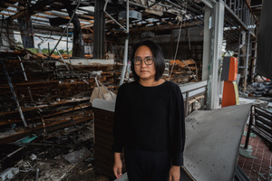 Kamonrat Phonsettalert, owner of the PTT station in Kantharalak, stands in front of the destroyed 7-Eleven weeks after a rocket strike during the Thai-Cambodian border clash killed seven and injured one. Three weeks after the Cambodian border clash, Kantharalak still bears the scars, including the July 24 rocket strike on a PTT station that killed eight civilians and injured several others. The station remains closed, leaving more than 50 employees in limbo as compensation issues remain unresolved.
