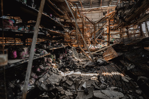Burnt shelves and collapsed debris inside the destroyed 7-Eleven at a PTT station in Kantharalak, weeks after a rocket strike during the Thai-Cambodian border clash. Three weeks after the Cambodian border clash, Kantharalak still bears the scars, including the July 24 rocket strike on a PTT station that killed eight civilians and injured several others. The station remains closed, leaving more than 50 employees in limbo as compensation issues remain unresolved.