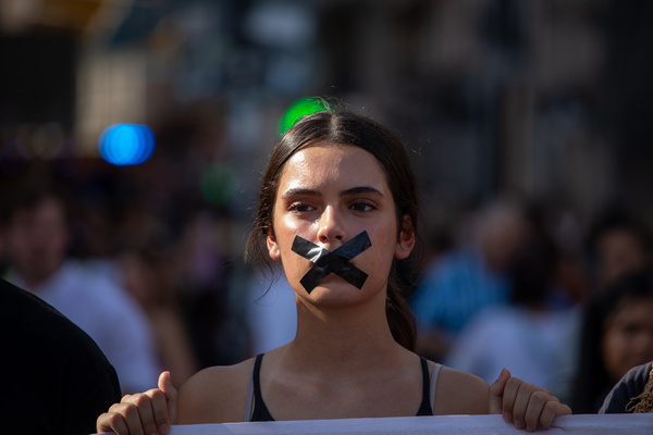 A protester with black electrical tape covering her mouth takes part during a rally at Madrid's Puerta del Sol for Afghan women's rights. August 15 marks the fourth anniversary of the Taliban's capture of Kabul, an event that marked their return to power in Afghanistan following the withdrawal of US and NATO troops. Since then, the country's situation has experienced a drastic decline, especially in terms of human rights.