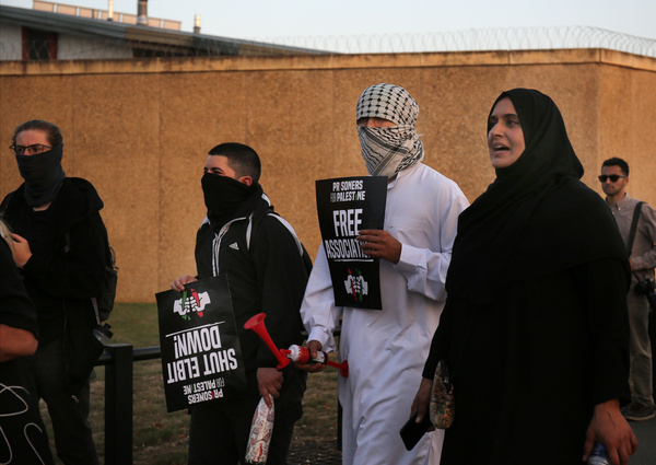Protesters march outside of the prison walls, chanting slogans during a Prisoners4Palestine launch at a rally outside HMP Peterborough. Prisoners4Palestine organized a rally marking one year since the Filton24 prisoners were jailed on remand, with three still held at Filton prison, including one on hunger strike. The demonstration also honored the 2004 Palestinian prisoners’ hunger strike while highlighting ongoing repression inside UK prisons. Protesters demanded the closure of Elbit Systems, an end to isolation and censorship, release on bail, transparency in government dealings with Israel and Elbit, and the removal of terrorism-related charges from the cases.