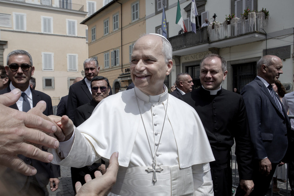 Pope Leo XIV greets the faithful after leading the Angelus prayer from the Apostolic Palace in Piazza della Liberta in Castel Gandolfo.