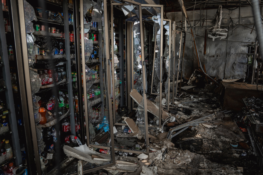 Shattered refrigerators and burnt debris inside the destroyed 7-Eleven at a PTT station in Kantharalak, weeks after a rocket strike during the Thai-Cambodian border clash. Three weeks after the Cambodian border clash, Kantharalak still bears the scars, including the July 24 rocket strike on a PTT station that killed eight civilians and injured several others. The station remains closed, leaving more than 50 employees in limbo as compensation issues remain unresolved.