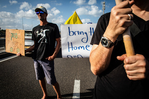 A protester holds up a sign as they block the main costal Highway near Beit Yanai. Demonstrators call on Israeli Prime Minister Benjamin Netanyahu to end the war in Gaza and to release all 50 Israeli hostages held by Hamas since October 7, 2023. On what was the biggest day of national mobilization, hundreds of thousands of people poured into the streets around the country to demand a Hostage release deal and an end to the war in Gaza.