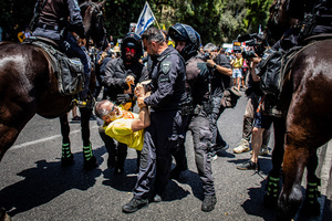 Israeli police officers carry a protester during a demonstration. Demonstrators call on Israeli Prime Minister Benjamin Netanyahu to end the war in Gaza and to release all 50 Israeli hostages held by Hamas since October 7, 2023. On what was the biggest day of national mobilization, hundreds of thousands of people poured into the streets around the country to demand a Hostage release deal and an end to the war in Gaza.
