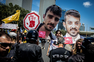 A protester holds up cardboard cuttings of Israeli hostages during a demonstration. Demonstrators call on Israeli Prime Minister Benjamin Netanyahu to end the war in Gaza and to release all 50 Israeli hostages held by Hamas since October 7, 2023. On what was the biggest day of national mobilization, hundreds of thousands of people poured into the streets around the country to demand a Hostage release deal and an end to the war in Gaza.